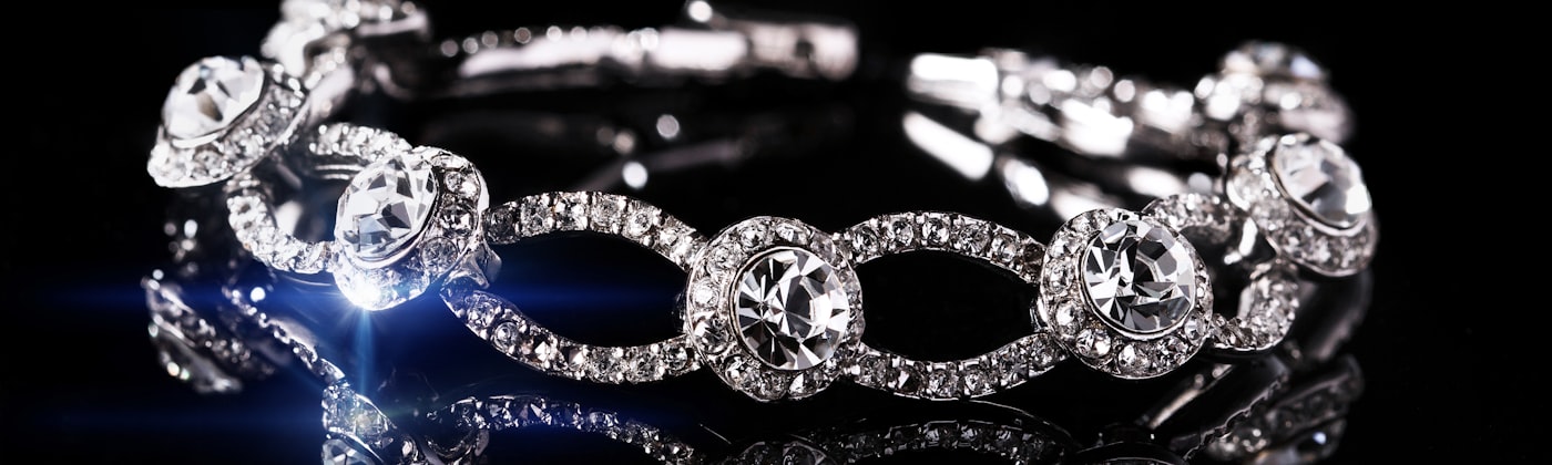 Diamond-set bracelet photographed on a dark reflective surface for a luxury jewellery store