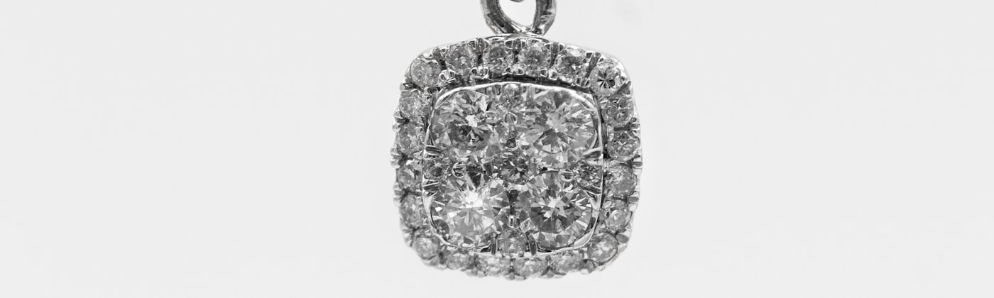Diamond pendant on a fine chain photographed on a clean white background for a product listing